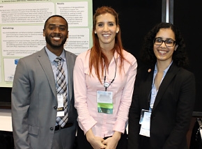 DOE Fellows gather in front of the student poster created by DOE Fellow Michelle Embon, center, at the Waste Management 2014 Conference.